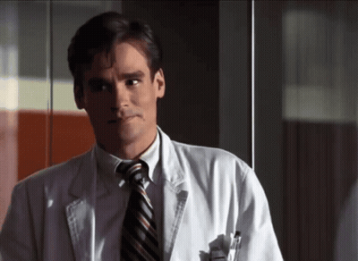 Man In White Coat And Tie Looking Left GIF