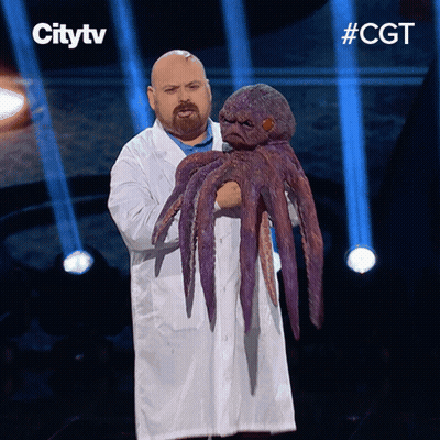 Man In White Coat Holding Purple Octopus Citytv Sign GIF