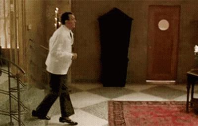 Man In White Coat Walking On Checkered Floor GIF