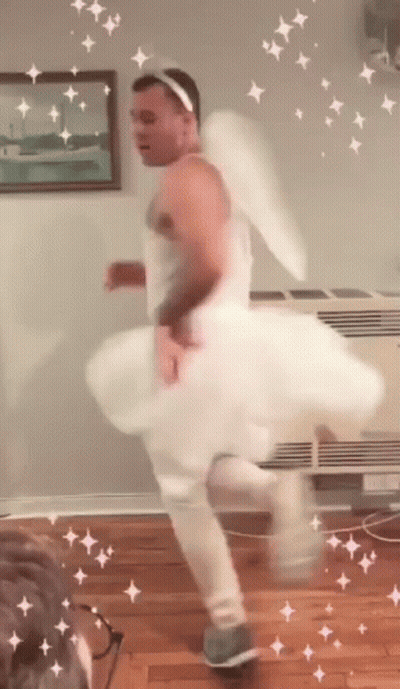 Man In White Dress And Angel Wings Dancing GIF