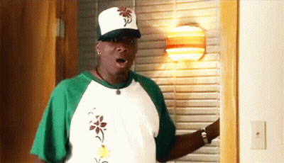 Man In White Hat And Green Shirt Standing In Room GIF
