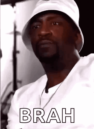 Man In White Hat And White Shirt Looking At Camera GIF
