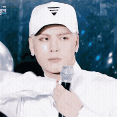 Man in White Hat Holding Microphone