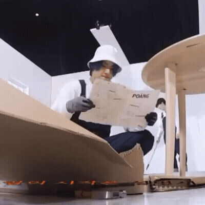 Man In White Hat Reading Newspaper Titled Poang GIF