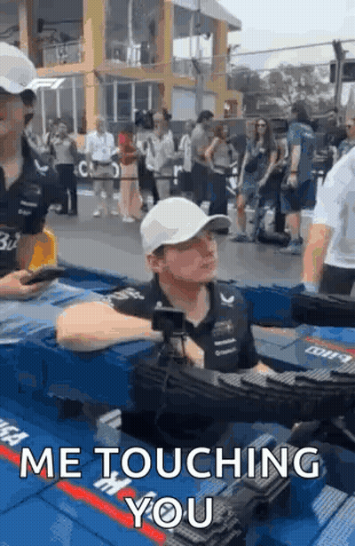 Man In White Hat Sitting In Pool Talking To Another Man GIF