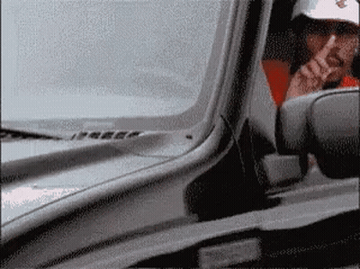 Man In White Hat Smoking While Driving GIF