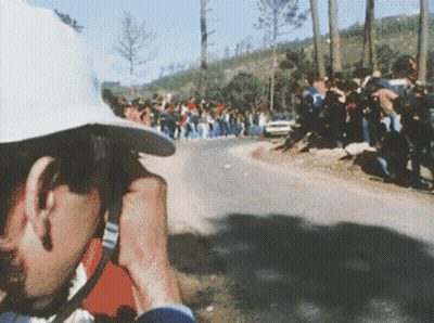 Man In White Hat Taking Photo Of Race GIF