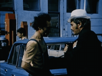 Man In White Hat Talking To Man In Overalls GIF