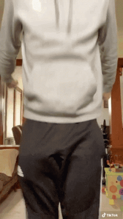 Man In White Hoodie And Black Pants With Hands In Pockets GIF