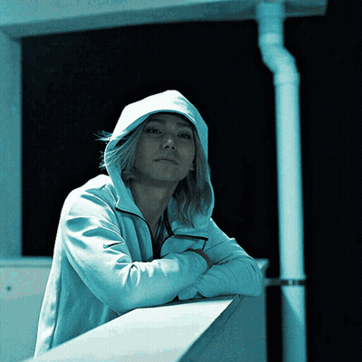 Man In White Hoodie Leaning On Wall GIF