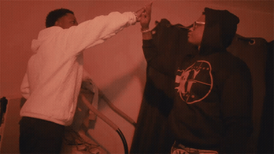 Man In White Hoodie Reaching To Black Hoodie Letter G GIF