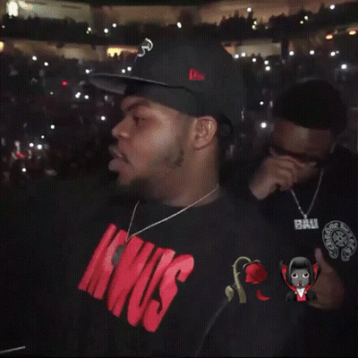 Man In White Hoodie Standing Before Crowd GIF