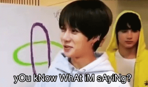 Man In White Hoodie Standing Next To Man In Yellow Hoodie Talking GIF
