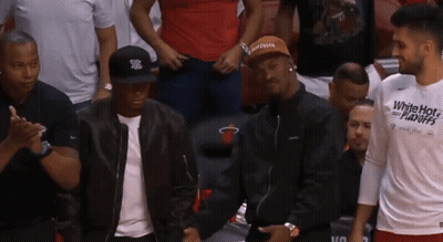 Man In White Hot Playoffs Shirt In Stands GIF