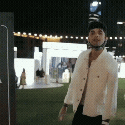 Man In White Jacket And Mask At Night GIF