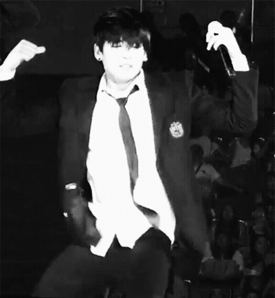 Man In White Jacket, Black Shirt, Purple Wall GIF