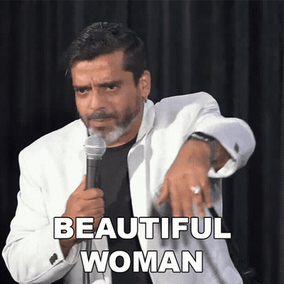 Man In White Jacket Holding Microphone Says Beautiful Woman GIF