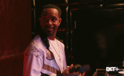 Man In White Jacket In Front Of BET Logo GIF