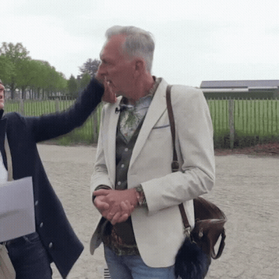 Man In White Jacket Kissed On Cheek GIF