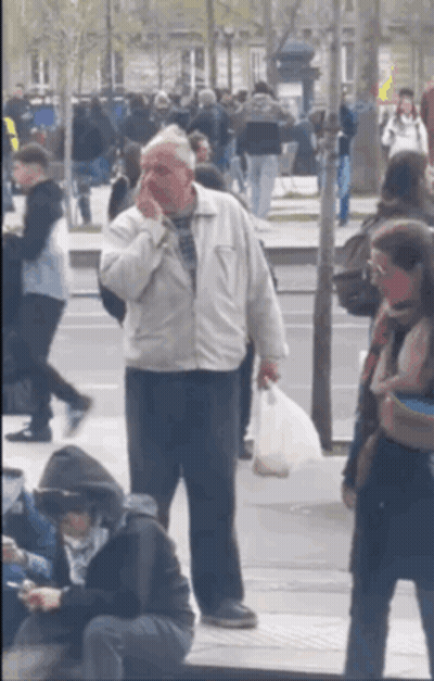 Man In White Jacket On Phone In Crowded Street GIF