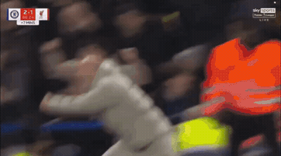 Man In White Jacket Running On Soccer Field With Score 2-1 GIF