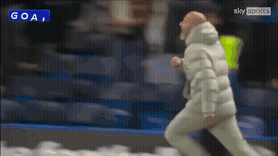 Man In White Jacket Running Past Goal Sign GIF