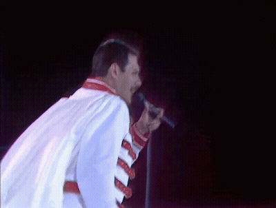 Man In White Jacket Singing Into Microphone GIF
