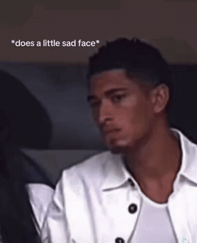 Man In White Jacket Sitting In Car Does A Little Sad Face GIF