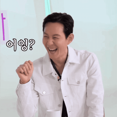 Man In White Jacket Smiling Pointing With Question Mark GIF