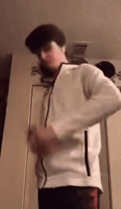 Man In White Jacket Standing In Front Of Door GIF