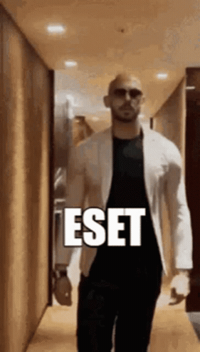 Man In White Jacket Walking Past ESET Sign GIF