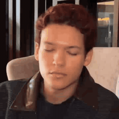 Man In White Jacket Walking Past ESET Wall GIF
