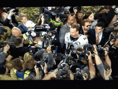 Man In White Jersey Surrounded By Crowd Taking Pictures GIF