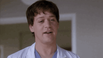 Man In White Lab Coat And Blue Scrub Making Funny Face GIF