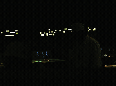 Man in White Lab Coat and Hat in Dark Room
