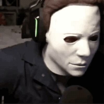 Man In White Mask Talking Into Microphone GIF