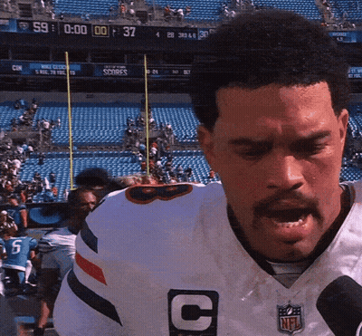 Man In White NFL Jersey With Letter C GIF