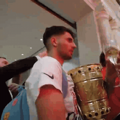 Man In White Nike Shirt Standing Next To Trophy GIF