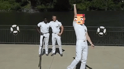 Man In White Pants Dancing At Microphone With Two Men Behind GIF