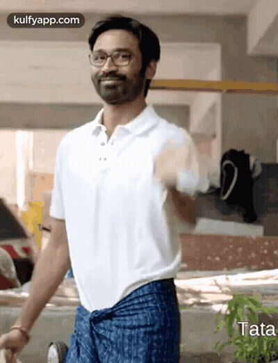 Man In White Polo And Blue Pants Standing In Front Of Building GIF