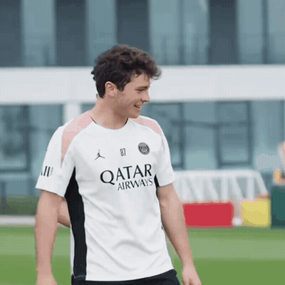 Man In White Qatar Airways Shirt Smiles GIF