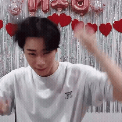 Man In White Reebok Shirt In Front Of Heart Curtain GIF