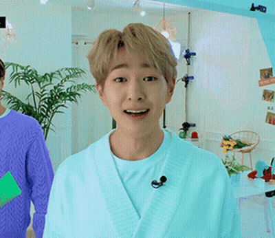 Man In White Robe And Microphone Smiling GIF