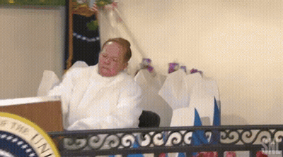 Man In White Robe At Podium GIF
