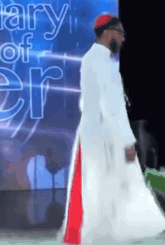 Man In White Robe In Front Of Diary Of Er Sign GIF