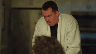 Man In White Robe Looking At Man In Black Shirt GIF