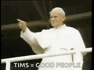 Man In White Robe Pointing From Balcony GIF