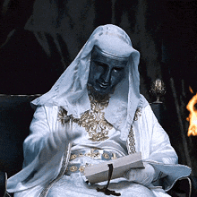 Man In White Robe Reading Book GIF