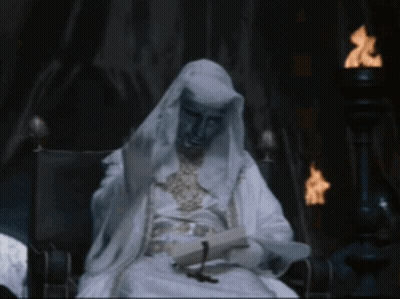 Man In White Robe Sitting In Chair GIF