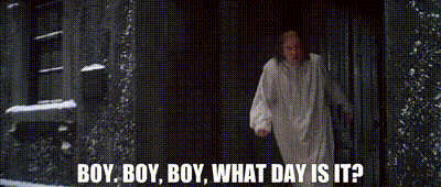 Man In White Robe Standing In Dark Room Talking GIF